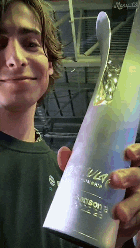 a young man is holding a trophy that says ' season 2 ' on it