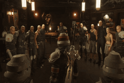 a group of bald people are holding hands in a dark room