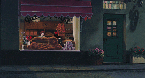 a bakery with a purple awning and a sign that says ' bakery ' on it