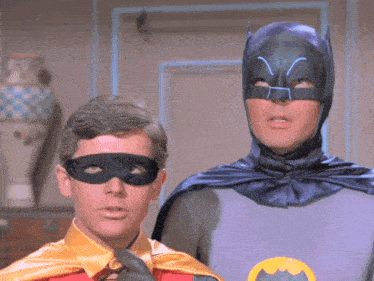 a man in a batman costume and a man in a robin costume