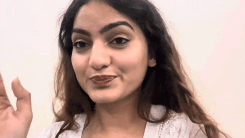 a close up of a woman making a funny face with her mouth open .