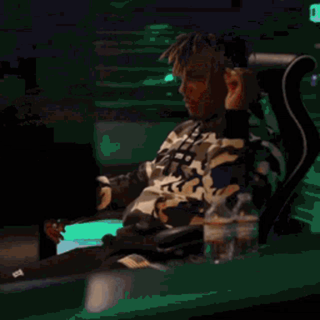 a man with dreadlocks is wearing a gray sweatshirt with a shark on it .