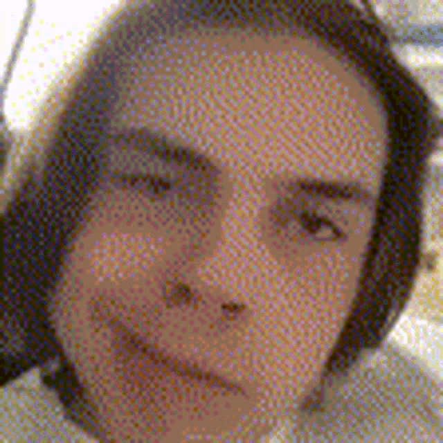 a close up of a woman 's face with a blurred background .