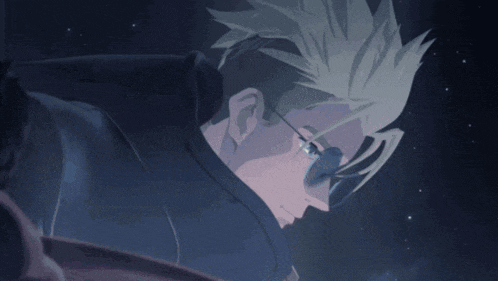 a man with glasses and a shaved head looks down