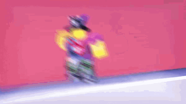 a blurry picture of a stack of bottles with a pink background