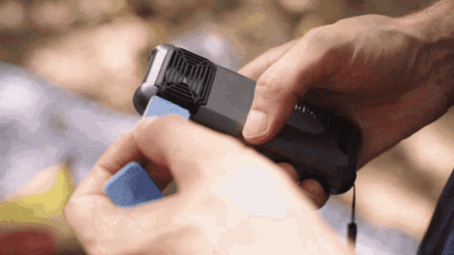 a person is holding a small device that says ' i ' on it