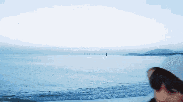 a person standing on a beach looking out over the ocean