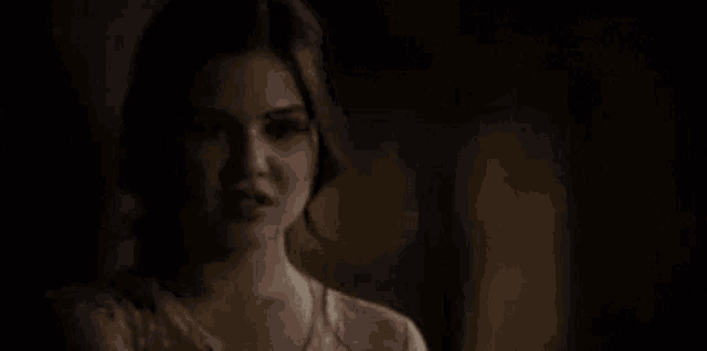 a close up of a person 's face with their mouth open in the dark .