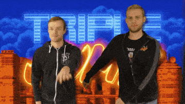 two men standing in front of a sign that says triple on it