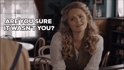 a woman sitting at a table with the words " are you sure it wasn 't you " written above her