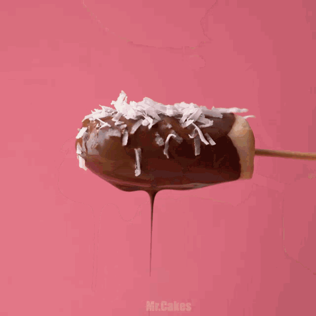 a wooden tray with bananas dipped in chocolate and sprinkles says mr.cakes