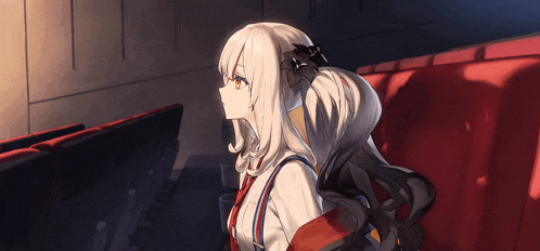 a girl with white hair is sitting in a dark room