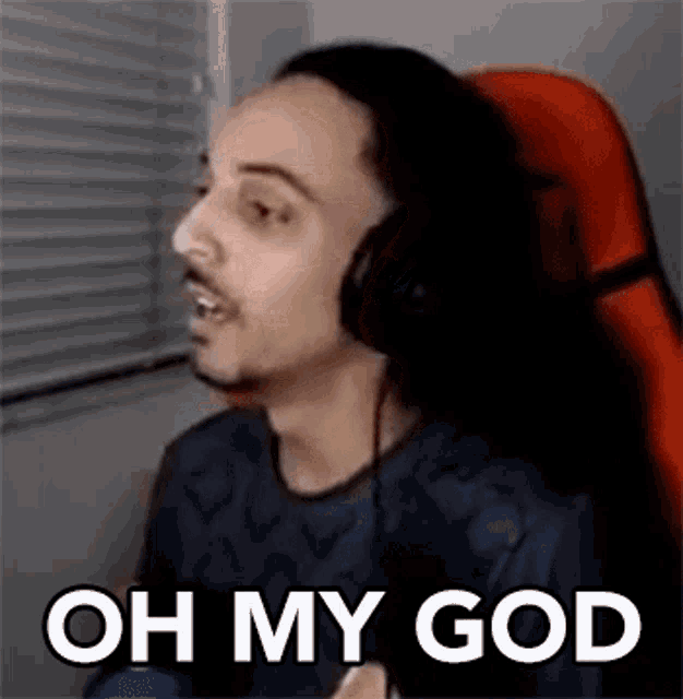 a man wearing headphones is sitting in a chair and making a funny face .