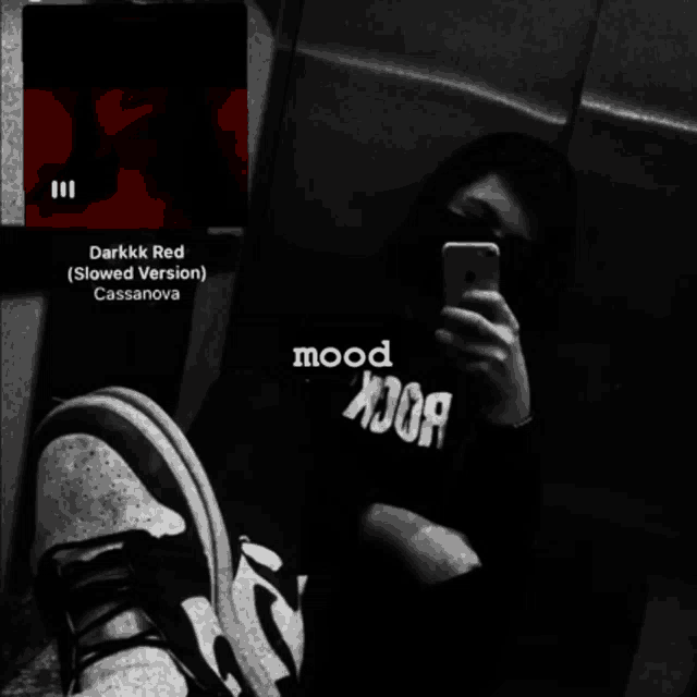 a black and white photo of a person taking a selfie with the words darkkk red on the bottom