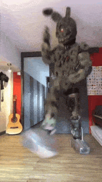 a person in a bunny costume is standing in a room with a guitar