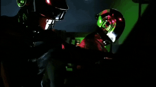 a man wearing a green helmet is sitting in a dark room .