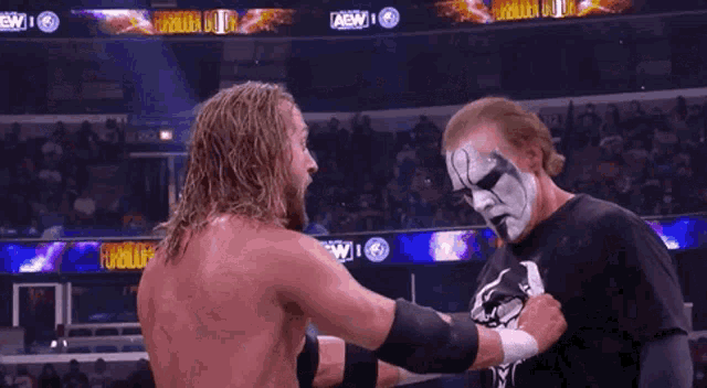 two wrestlers are standing next to each other in a ring with a sign that says forbidden door on it