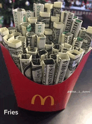 a red mcdonald 's french fries container filled with dollar bills