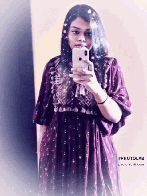 a woman in a purple dress is taking a selfie with her iphone