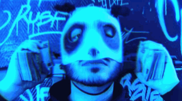 a man wearing a panda mask is holding a bunch of money in his hands