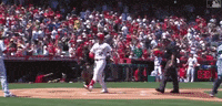 a baseball game is being played in a stadium with a clock that says 8:33