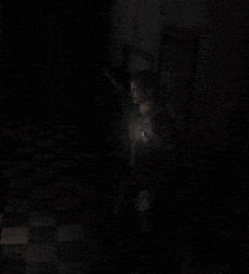 a man is standing in the dark with a light on his chest