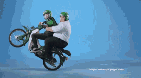 a man and a child on a green motorcycle with the word go in the background