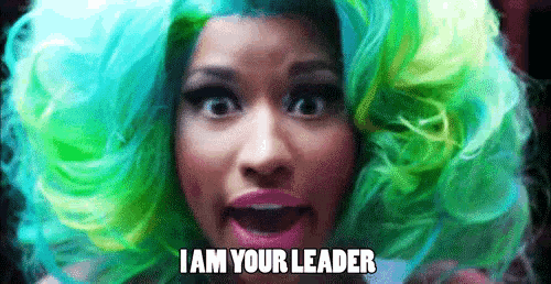 a woman in a green and blue wig is saying i am your leader