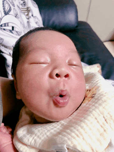a baby making a funny face with his mouth wide open