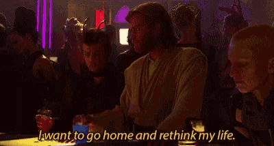 a man sitting at a table with the words " i want to go home and rethink my life " above him