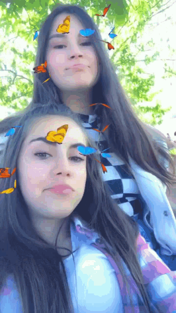 two young girls with butterflies on their faces