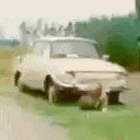 a white car is parked on the side of the road in a parking lot .