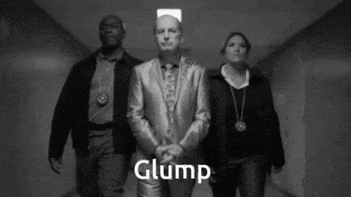 a man in a suit and tie is being escorted by two police officers and the word glump is on the bottom right