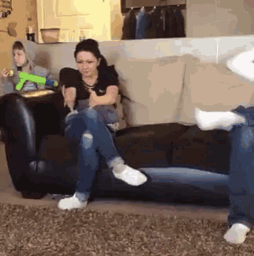 a woman is sitting on a couch with her feet on the floor