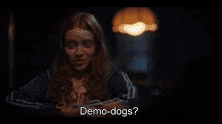 a man in a hat says demo-dogs while holding a gun