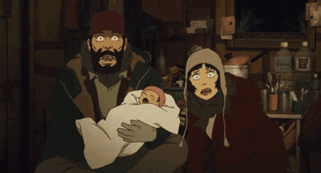 a man and a woman holding a baby in a dark room