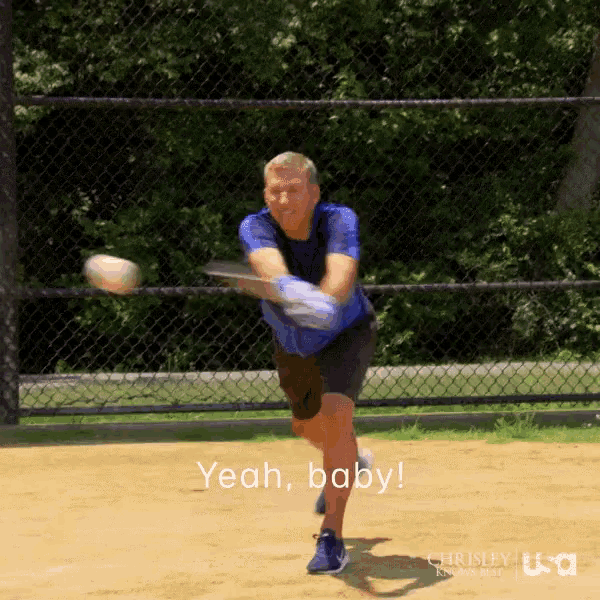 a man in a blue shirt is throwing a baseball with the words yeah baby below him