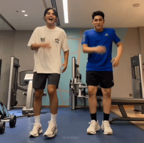 two men are dancing in a gym with the words olpabwu on the bottom right
