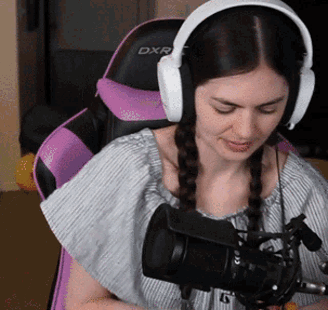 a woman wearing headphones and a dxr chair