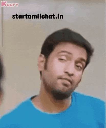 a man in a blue shirt is making a funny face and the website starttamilchat.in is visible behind him