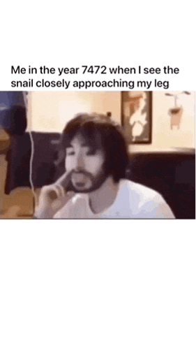 a man is dancing in a room while a snail approaches him .