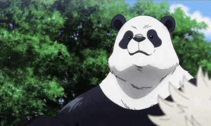 a black and white panda bear is standing in front of some trees .