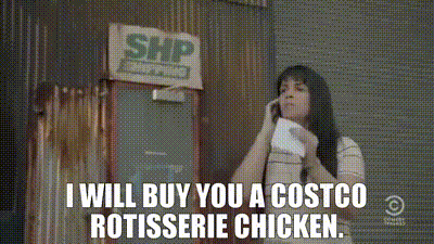 a woman is talking on a cell phone in front of a costco rotisserie chicken sign
