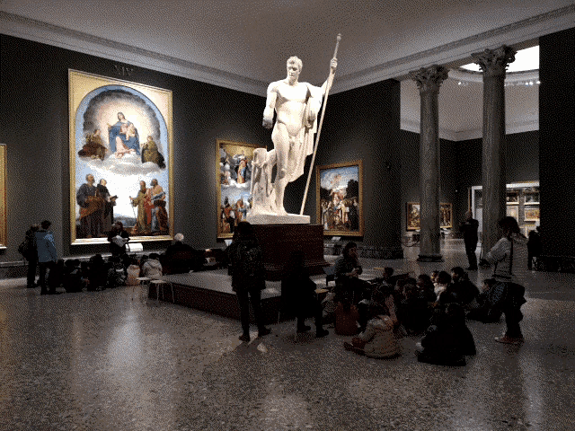 a statue of a man with a spear is in a museum