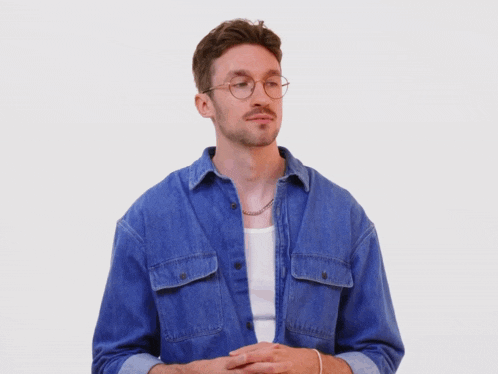 a man with glasses and a chain around his neck