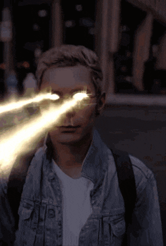 a man in a denim jacket has a lightning bolt in his eyes