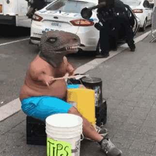 a man dressed as a dinosaur is playing drums on the street