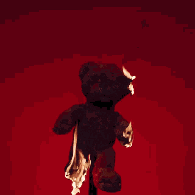 a teddy bear with flames coming out of its legs