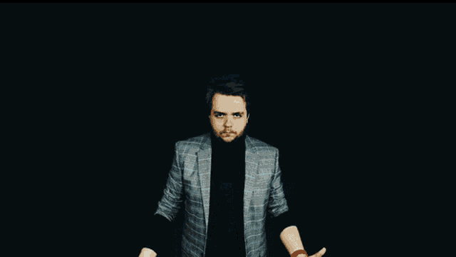 a man with a beard is holding a blue ball in his hands