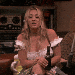 a woman sitting in a chair with a bottle of beer in her hand